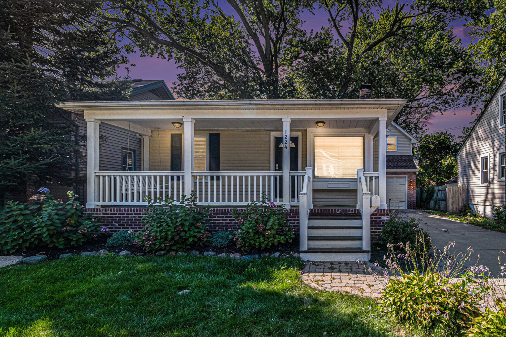 A house with a porch and front yard.